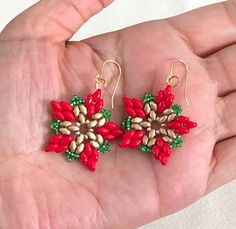 These Poinsettia Earrings capture the holiday spirit with a stunning floral design. Crafted using vibrant red and gold super duo glass beads, complemented by green seed beads, they resemble the iconic poinsettia flower. Finished with gold-colored earring wires, these earrings are a cheerful and festive addition to any outfit. Lightweight and eye-catching, they are perfect for Christmas parties, holiday gatherings, or as a thoughtful gift for someone who loves seasonal accessories. Celebrate the Diy Earrings Christmas, Holiday Earrings Diy, Beaded Christmas Earrings, Christmas Beaded Earrings, Beading Earring, Beaded Crosses, Poinsettia Earrings, Christmas Beading, Christmas Jewelry Diy