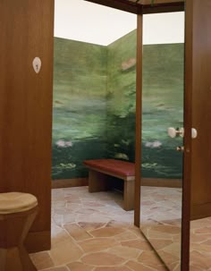 an open door leading to a bathroom with a painting on the wall and a bench in front of it