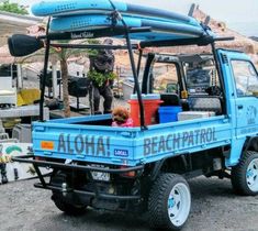 a blue truck with a kayak on the back