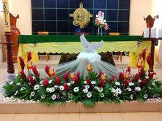 the altar is decorated with flowers and birds on it's sides, along with other decorations