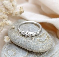 Granulation and Barnacle Cluster Sterling Silver Stacker Ring. Delicate, organic design inspired by little barnacles that cover the sea rocks. The rings are made by first creating tiny silver granulations and soldering each one to in an irregular cluster on a handmade ring band. I sand and polish the ring and give it a to a brushed satin finish. I then use a burr to drill out some of the granulations and polish the centre of each, to give a high shine finish. The polished centres of the barnacles, gives the illusion of sparkling stones. Ring Size: These are custom handmade to your required size. If you are unsure of the ring size required, please order the ring and sizer. The sizer will be posted to you first, so that you can order the correct size ring. Ring Shank: 1.8mm Material: Granula Granulation Ring, Personalized Silver Jewelry, Sterling Silver Layered Necklace, Slim Ring, Wax Ring, Ocean Inspired Jewelry, Bubble Ring, Layered Necklaces Silver, Organic Rings