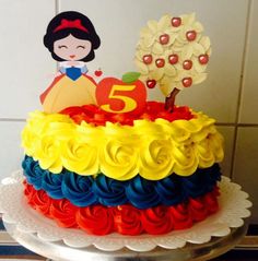 a birthday cake decorated with an image of snow white and the seven dwarfs on top