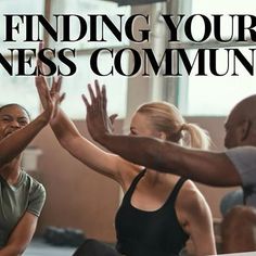 a group of people sitting on the floor with their hands in the air