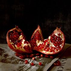 two pomegranates cut in half on a table