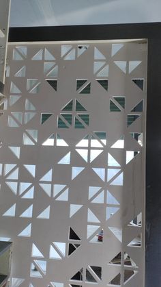 an open window with white geometric designs on it