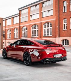 a red sports car parked in front of a building