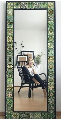 a woman sitting on a chair in front of a mirror