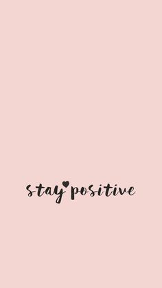 the words stay positive written in black ink on a pink background