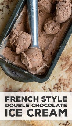 a scoop of ice cream in a pan on top of a table next to a spoon