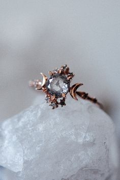 a diamond ring sitting on top of a rock