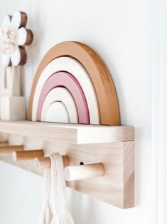 a wooden shelf with some plates on it and a bag hanging from the wall next to it