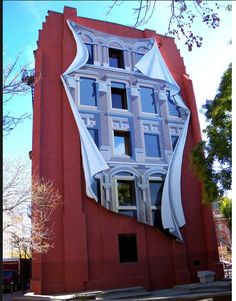 a large building with an interesting design on it's side