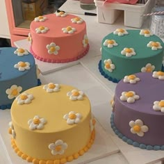 there are many cakes on the table with different colors and designs for each individual to choose from