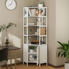 a room with a desk, chair and clock on the wall next to a bookcase