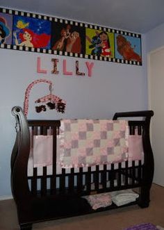 a baby crib in a room with pictures on the wall