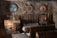 an old fashioned bedroom with stone walls and wood furniture