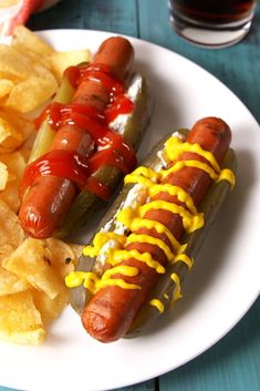 two hot dogs and chips on a plate