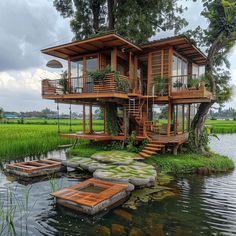 a house built into the side of a body of water with plants growing on it