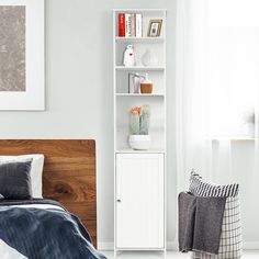 a bedroom with a white bookcase and blue bedding