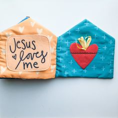 two pieces of fabric with the words jesus loves me and a heart on one side