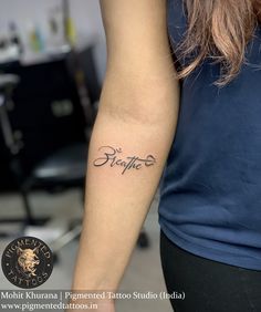 a woman with a tattoo on her arm that says, be grateful in cursive writing