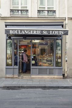 a store front with people standing in the doorway