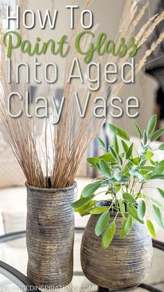 two vases with plants in them sitting on a table