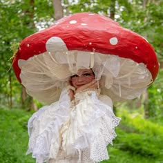 a woman in white dress and red mushroom hat