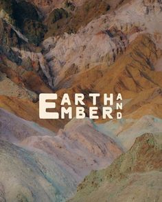 an image of the earth and ember logo on top of some mountain tops with mountains in the background