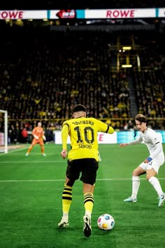 two soccer players are playing on the field