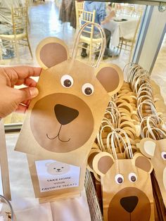 paper bag shaped like a bear and two smaller bears in front of a basket full of cookies