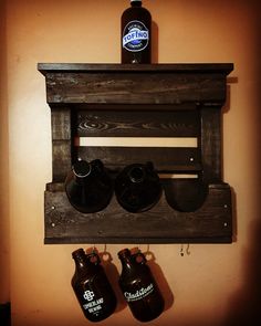 a wooden shelf with two beer bottles on it and a bottle opener attached to the wall