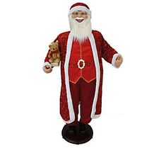 a santa claus figure holding a teddy bear