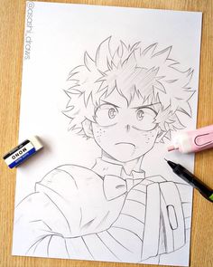 a drawing of an anime character on paper with marker pens and crayons next to it