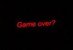 the words game over are lit up in the dark