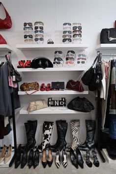 there are many pairs of shoes and purses on the shelves next to each other