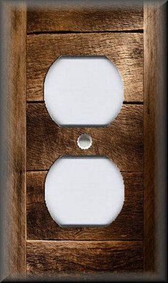 two white light switch plates mounted to a wooden wall with black frame and wood grained finish