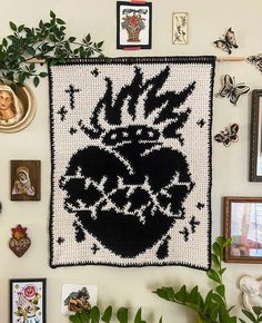 the wall is covered with pictures and other items, including a crocheted heart