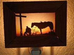 an image of a horse in a frame with a man next to it and a cross on the wall