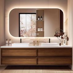 a bathroom with a large mirror above the sink and two vases on the counter