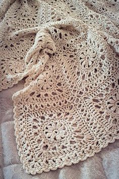 an old crocheted doily is laying on a bed