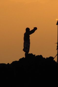 a person standing on top of a pile of dirt