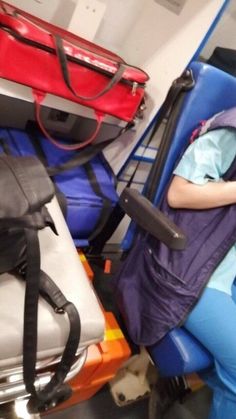 a woman sitting in a chair next to luggage