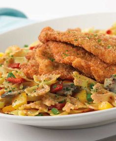 a white plate topped with pasta and fried chicken