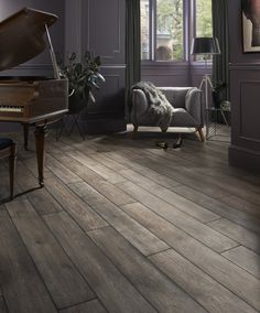 a living room filled with furniture and a piano