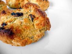 three blueberry scones sitting on top of a white plate next to each other