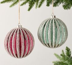 two ornaments hanging from a christmas tree