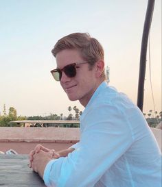 a man wearing sunglasses sitting at a table