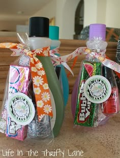 three candy bars wrapped in cellophane and tied with ribbons, sitting on a counter