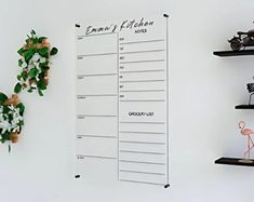 a wall mounted shelf with a calendar and flamingo figurines next to it